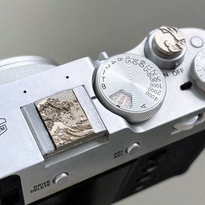 Close-up of a camera sea wave hot shoe cover and shutter release