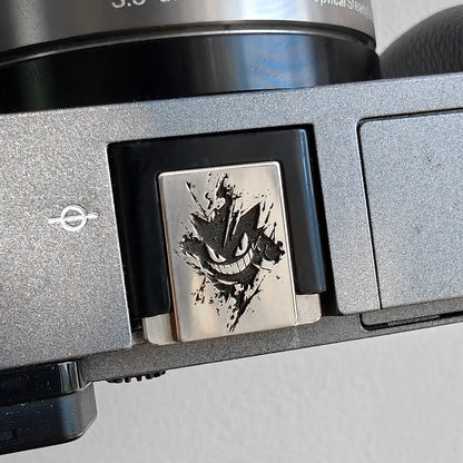 white copper gengar hot shoe cover on digital camera