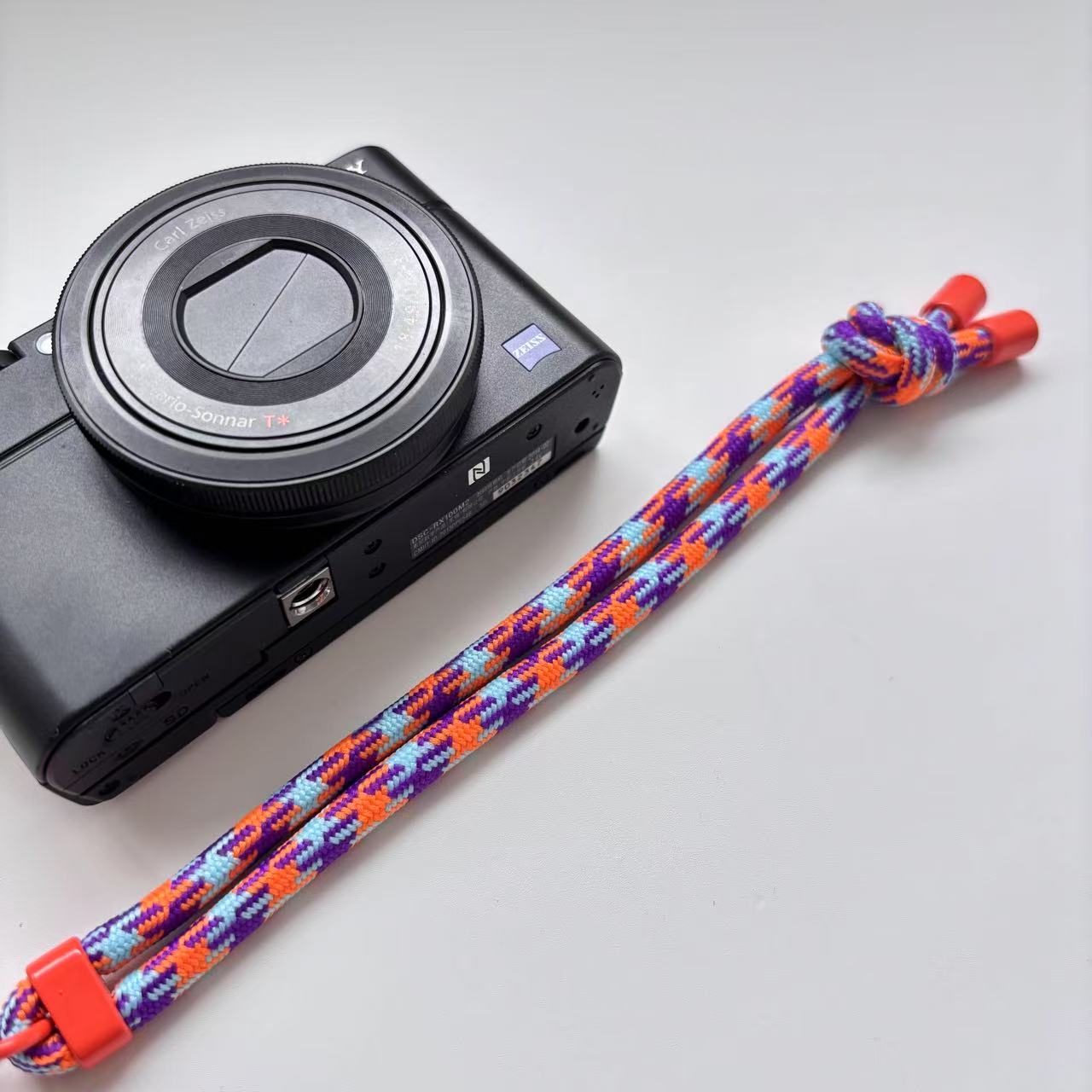 orange purple paracord camera wrist strap on Sony camera