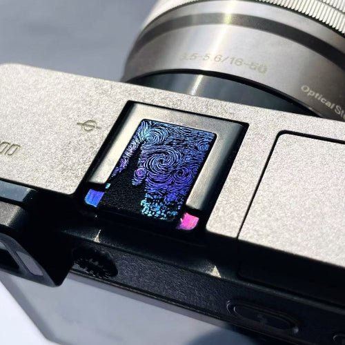 Titanium camera hot shoe cover with starry night inspired design