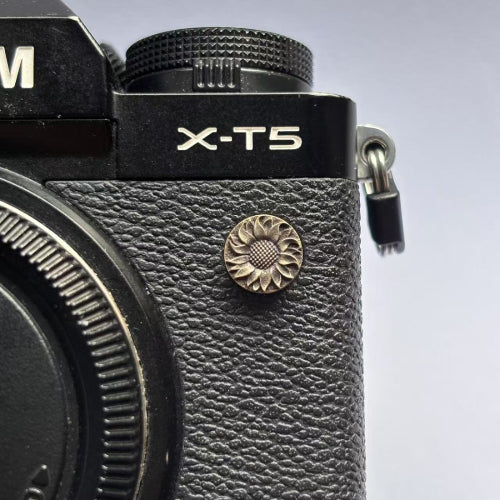 sunflower design flash remote pc sync terminal cap cover on a black Fujifilm X-T5 camera