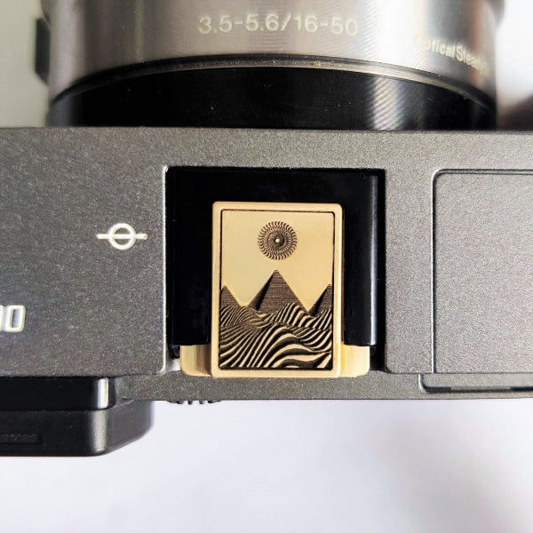Close-up of a camera pyramid hot shoe cover on sony camera