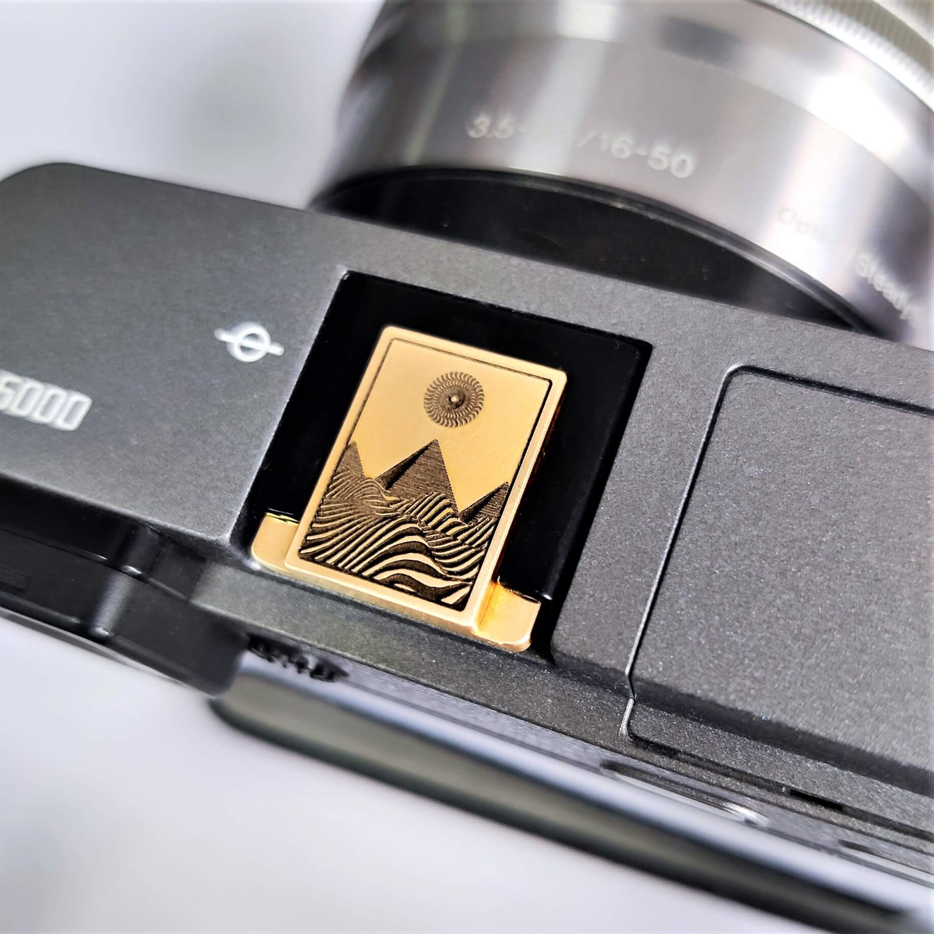 gold brass engraved pyramid hot shoe cover front view
