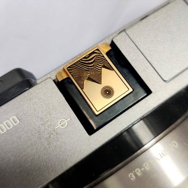 premium gold engraved camera hot shoe cover on camera