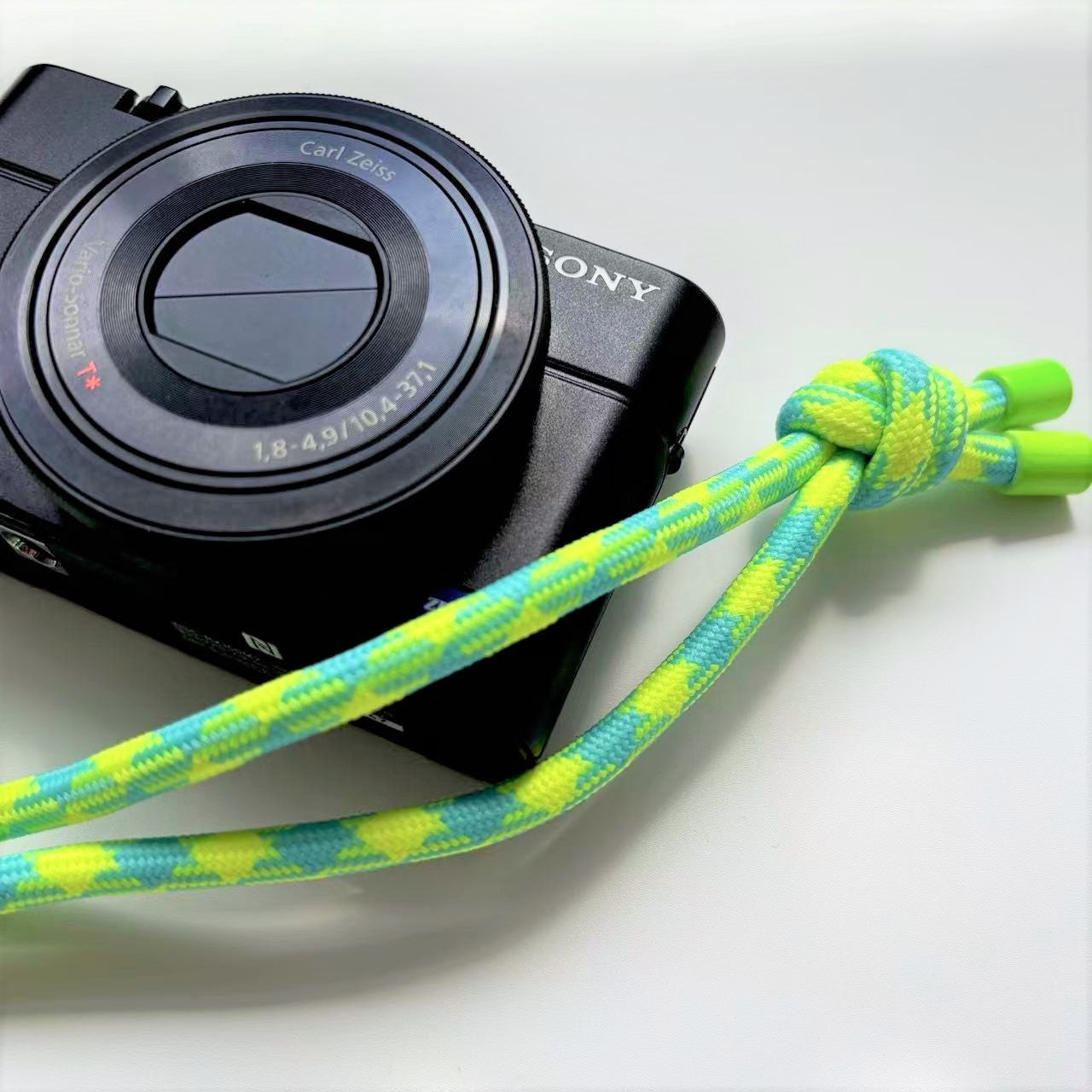 Sony camera with a colorful strap on a white background