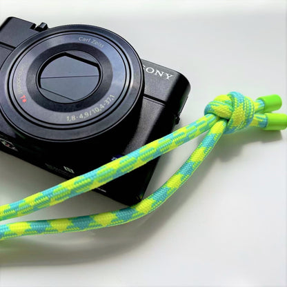 Sony camera with a colorful strap on a white background
