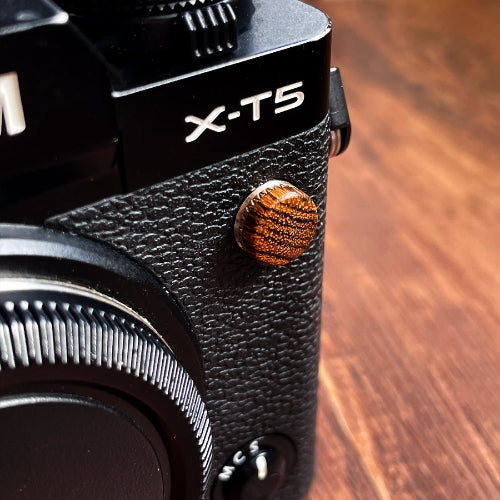 golden wood flash remote pc sync terminal cap cover on a black Fujifilm X-T5 camera