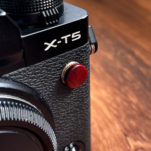rose wood flash remote pc sync terminal cap cover on a black Fujifilm X-T5 camera