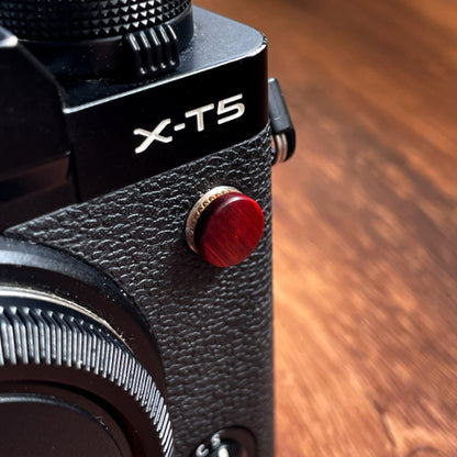 rose wood flash remote pc sync terminal cap cover on a black Fujifilm X-T5 camera